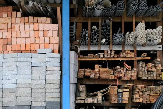 Stacked pipes, bricks and hardware construction materials