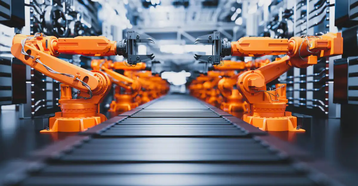 Row of orange industrial robot arms on a production line